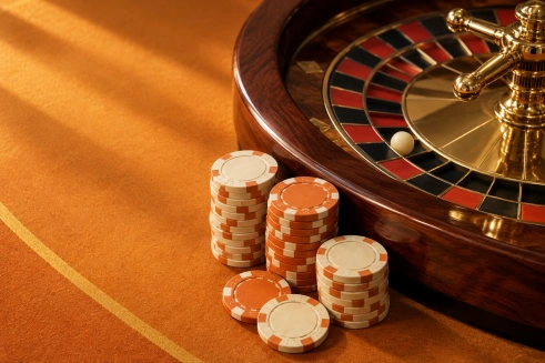 Fichas naranjas y claras junto a una ruleta